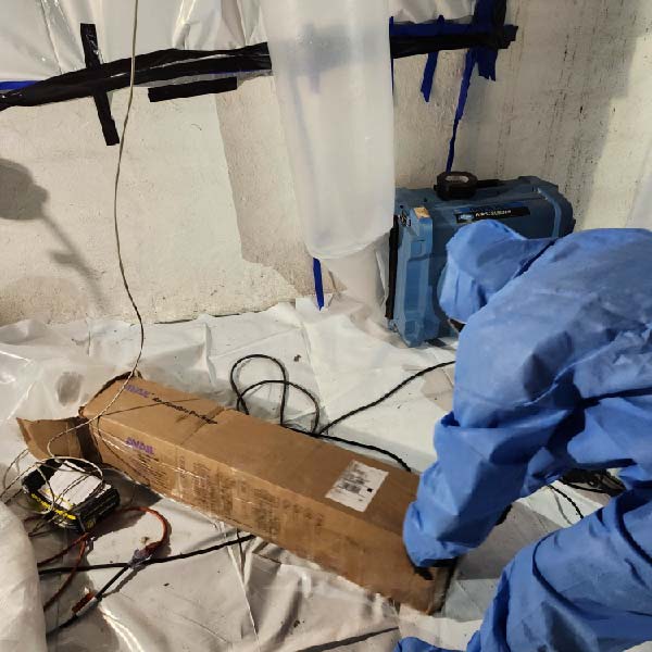 Asbestos abatement plan being reviewed by certified team