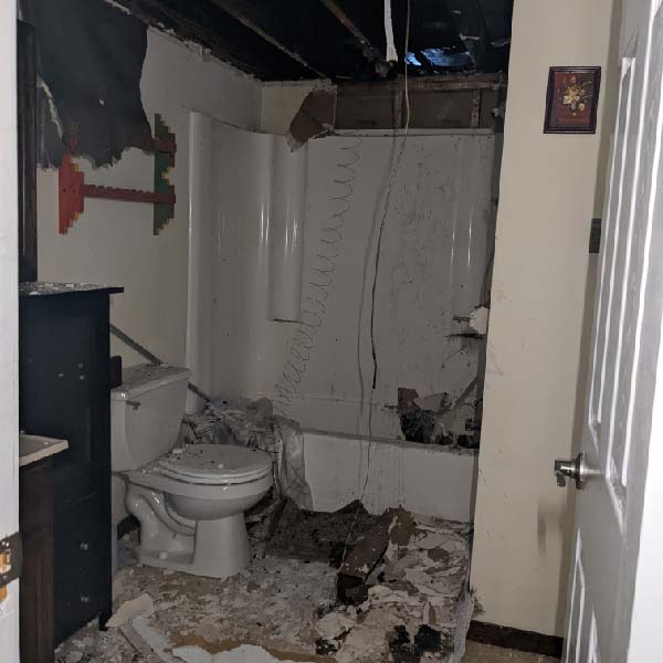 Specialized equipment removing water and cleaning fire-damaged debris