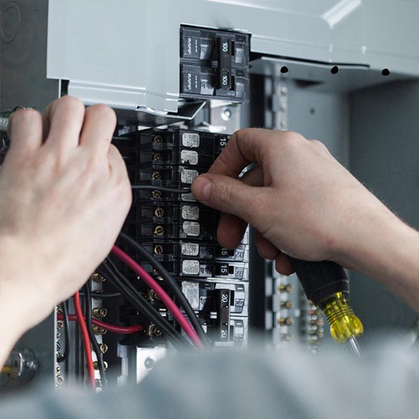 Licensed electrician upgrading electrical panel and wiring in home
