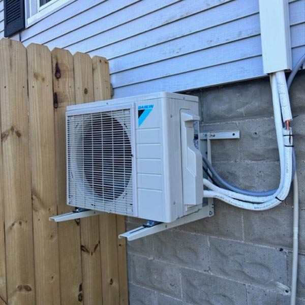 Technician performing HVAC maintenance and installing energy-efficient system