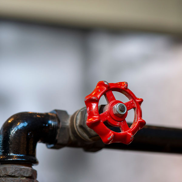 Plumber repairing residential water line and providing trenchless pipe lining services