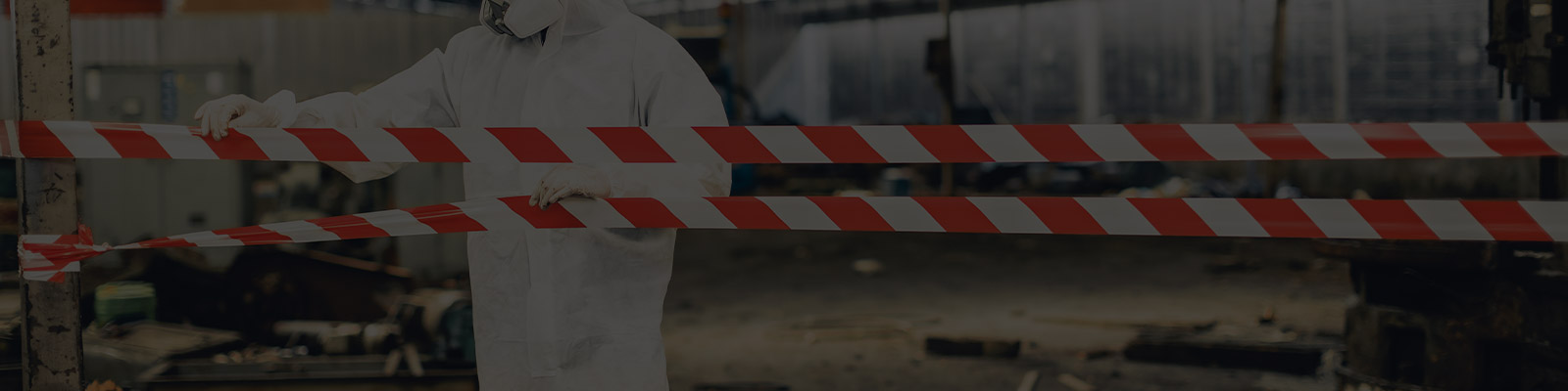 Asbestos abatement with KMB professional in hazmat suit sealing off area