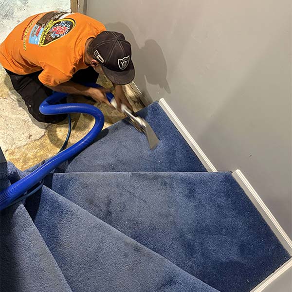 Water restoration team cleaning damage from water